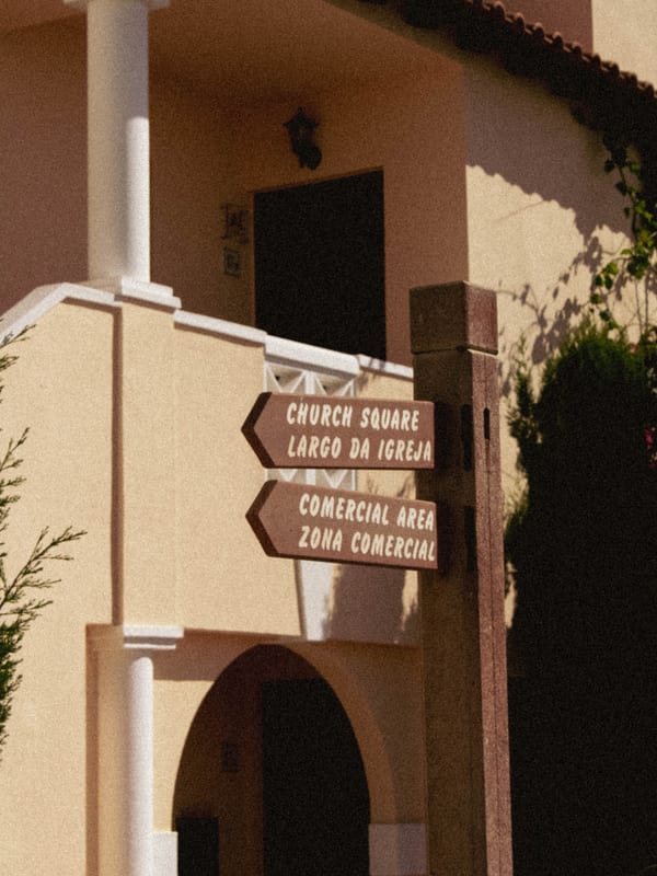 Directional signs on colonial building facade